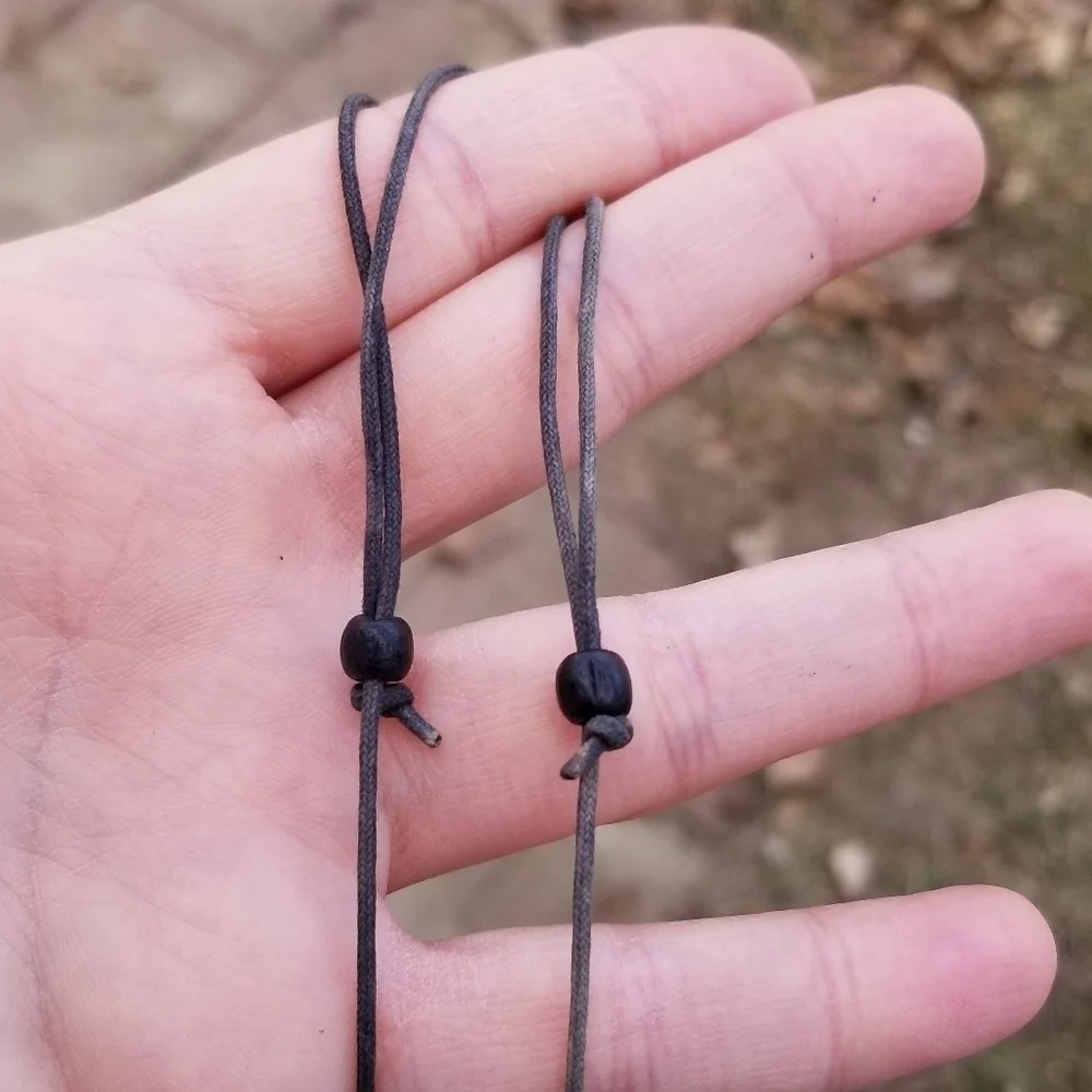 black wooden fan necklace on adjustable drawstring